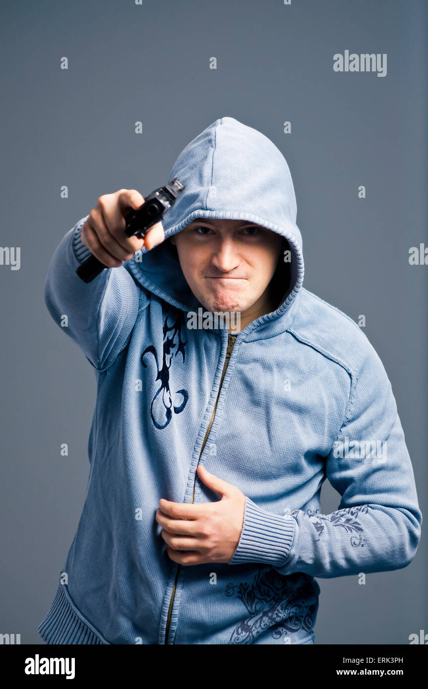 Aggressive young man with gun. Stock Photo