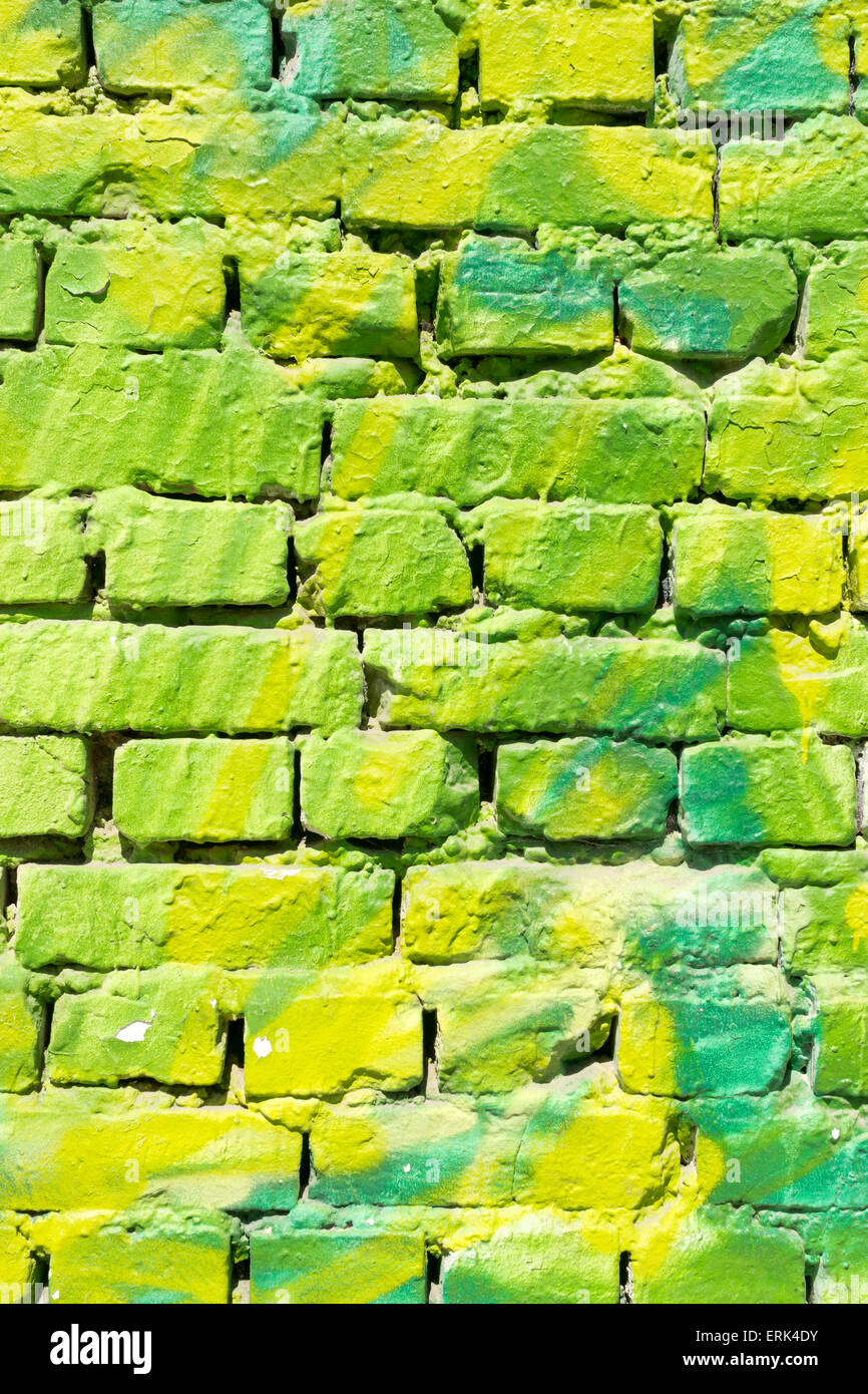 Closeup of modern urban street art using green spray paint and a white