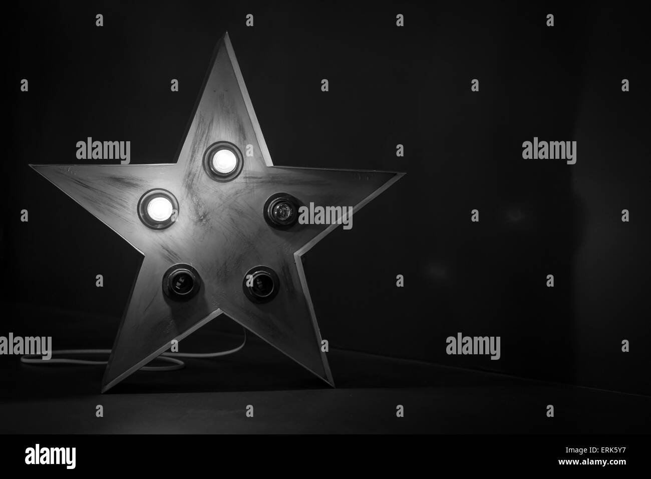 Single red soviet star lamp display with broken bulbs in black and white Stock Photo