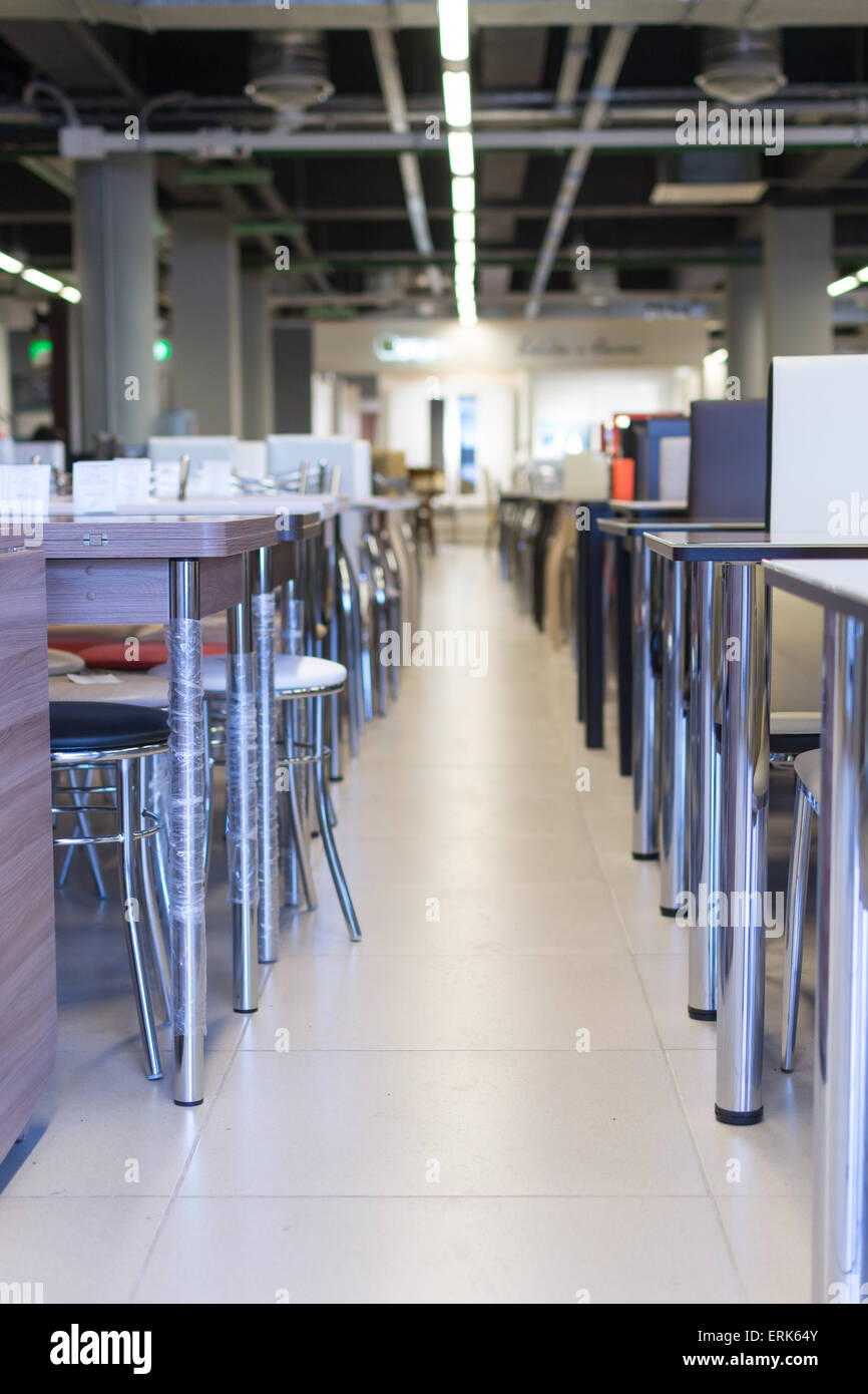 Rows Of Office Desks And Chairs On Display In A Market Stock Photo