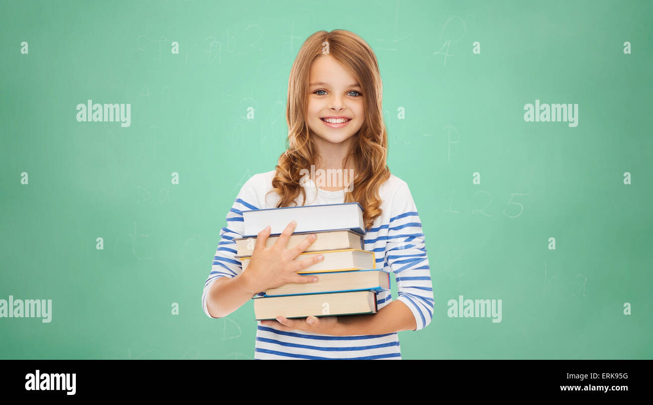 happy little student girl with many books Stock Photo - Alamy