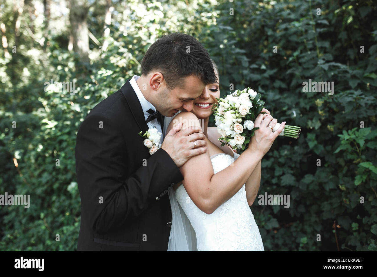 Beautiful wedding couple posing in park Stock Photo - Alamy