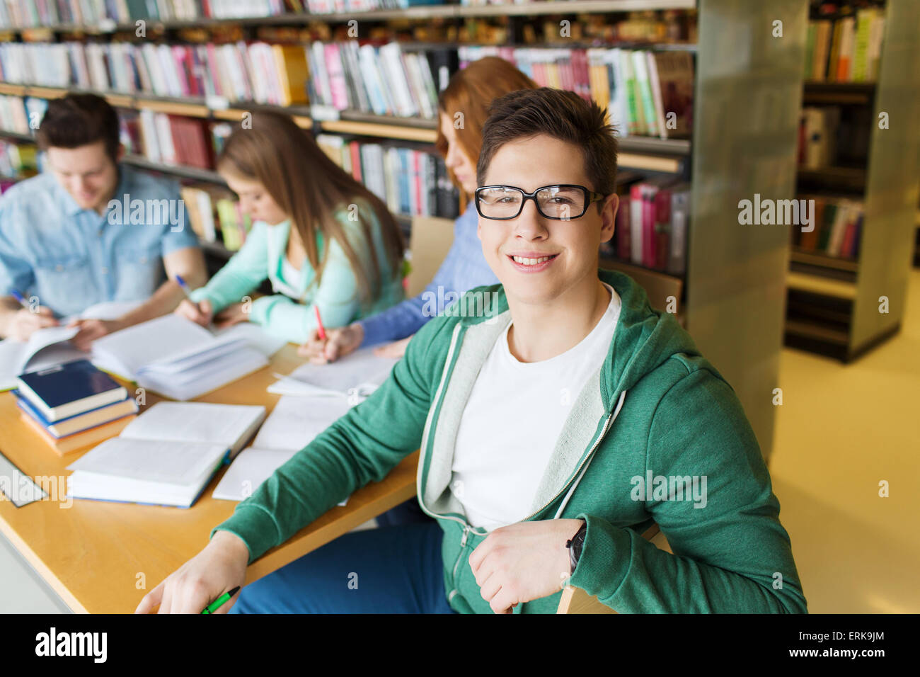 happy student boy reading books in library Stock Photo - Alamy