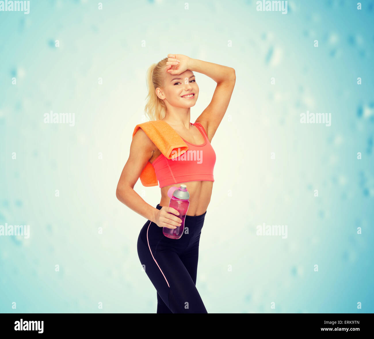 smiling sporty woman with towel and water bottle Stock Photo - Alamy