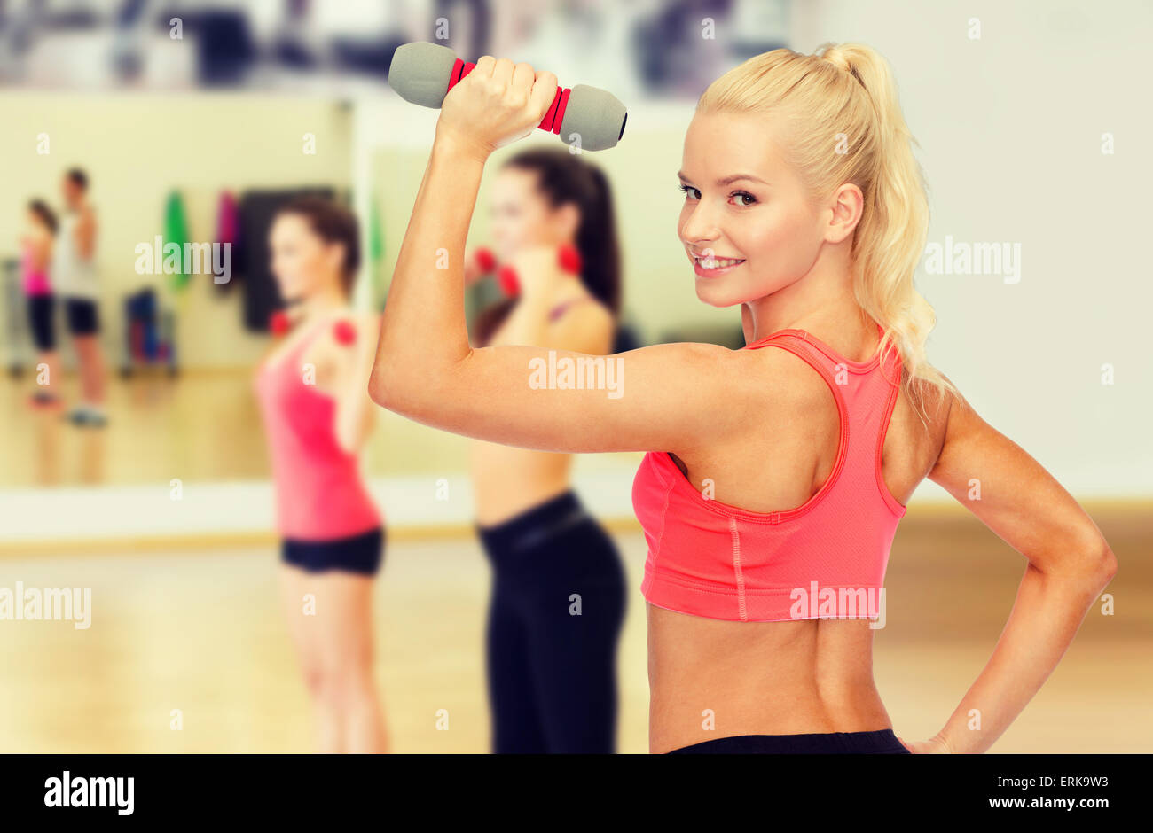 young sporty woman with light dumbbell Stock Photo