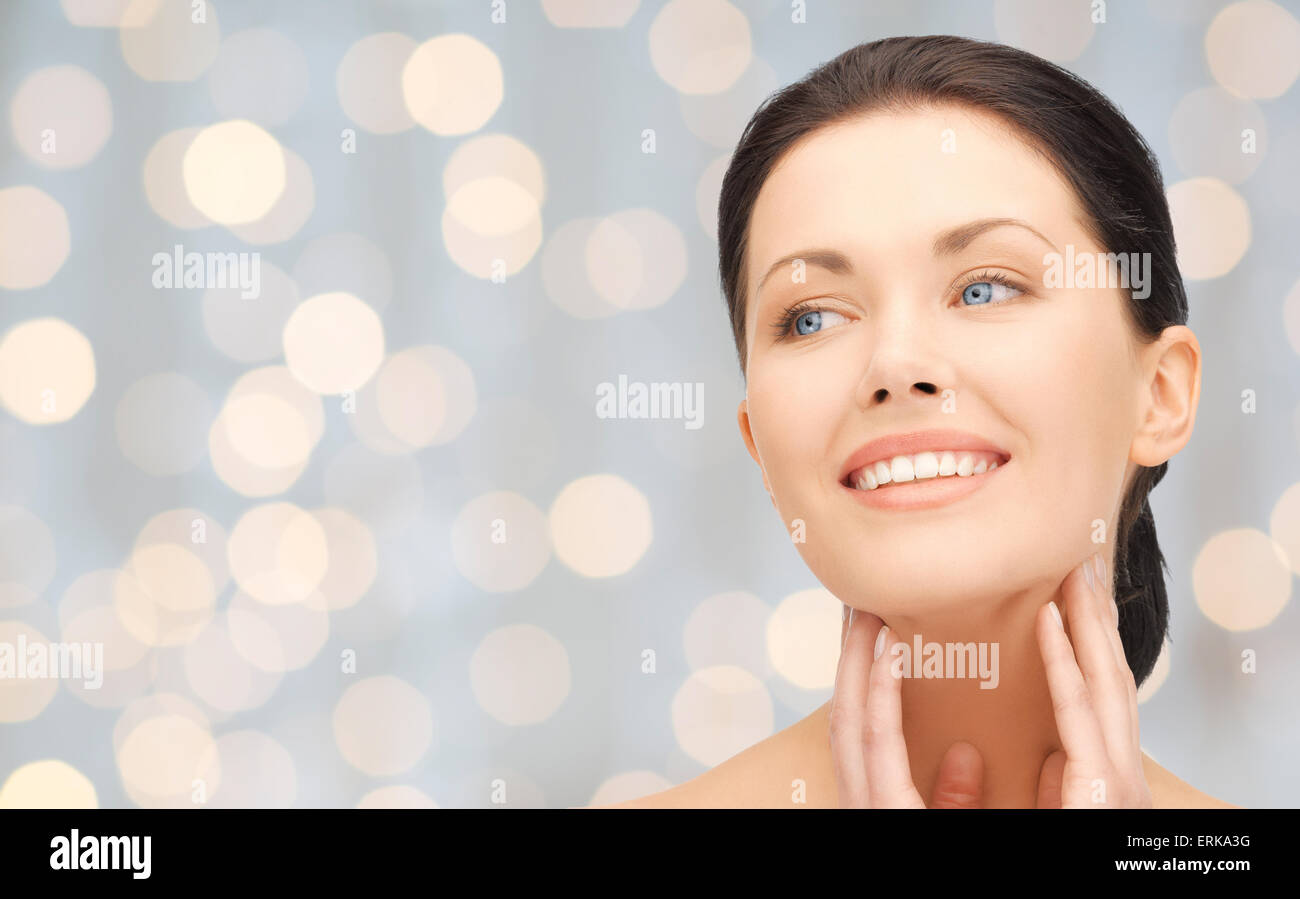 beautiful young woman touching her face and neck Stock Photo - Alamy