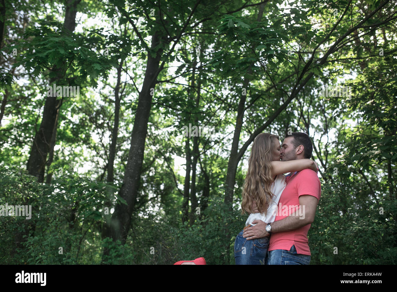 Cute couple in a forest Stock Photo - Alamy