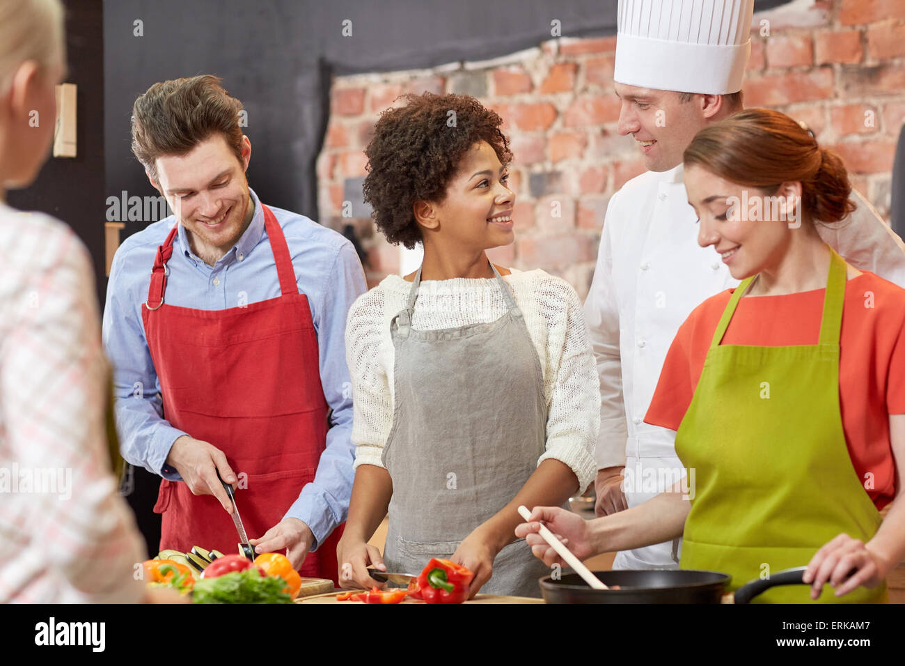 happy friends and chef cook cooking in kitchen Stock Photo - Alamy