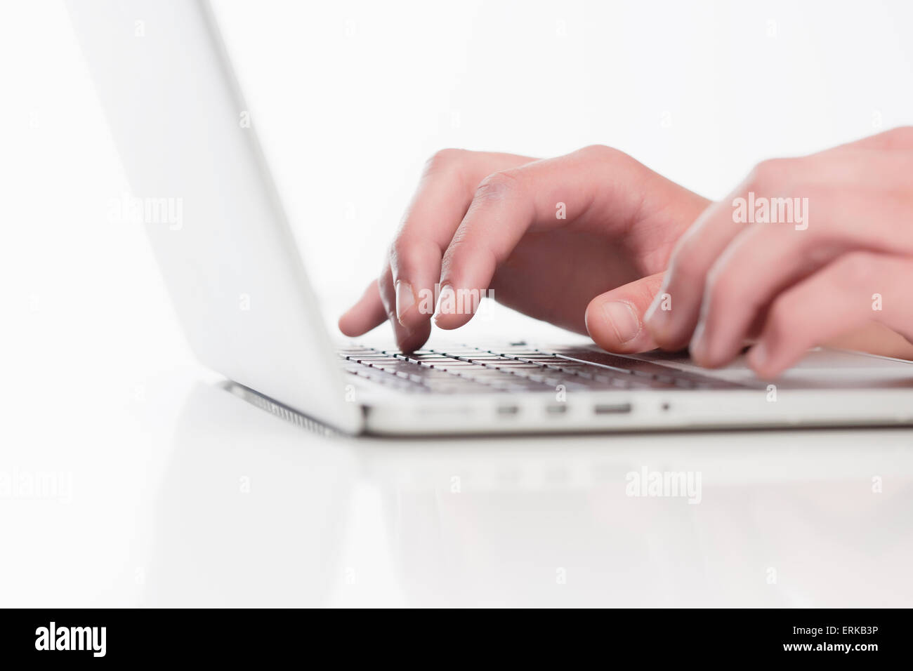 Closeup of Fingers Using Laptop Keyboard Stock Photo