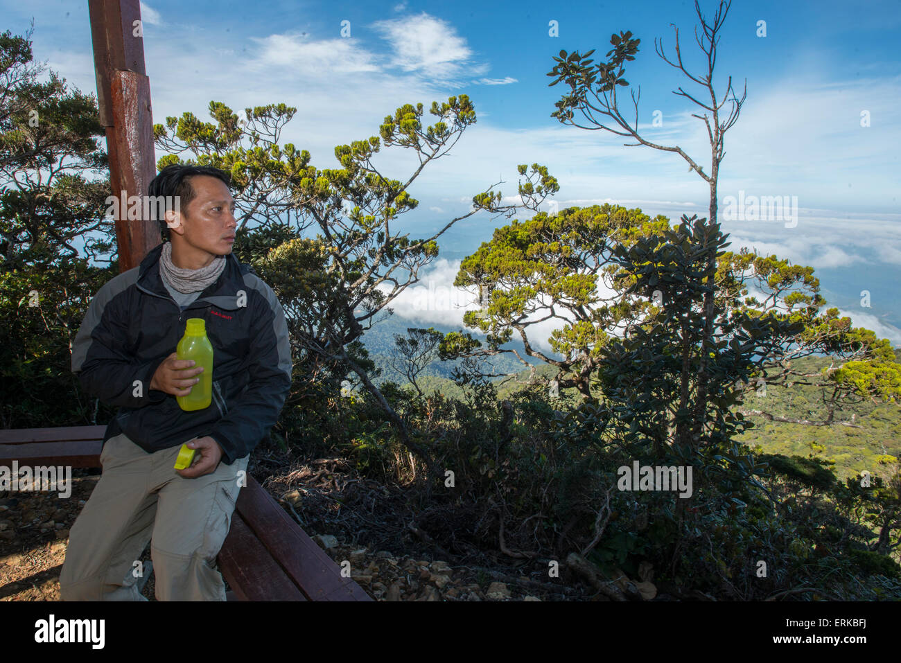 Man takes a rest at rest stop, Mount Kinabalu, Sabah, Borneo, Malaysia Stock Photo