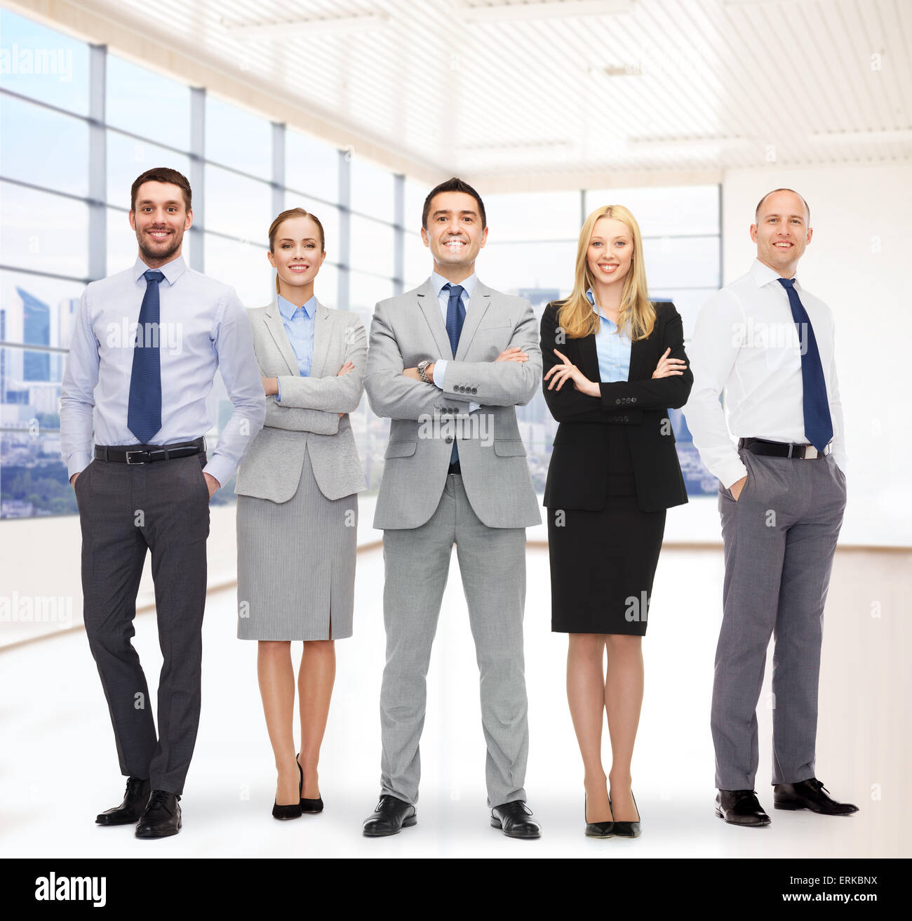 group of smiling businessmen over office room Stock Photo - Alamy