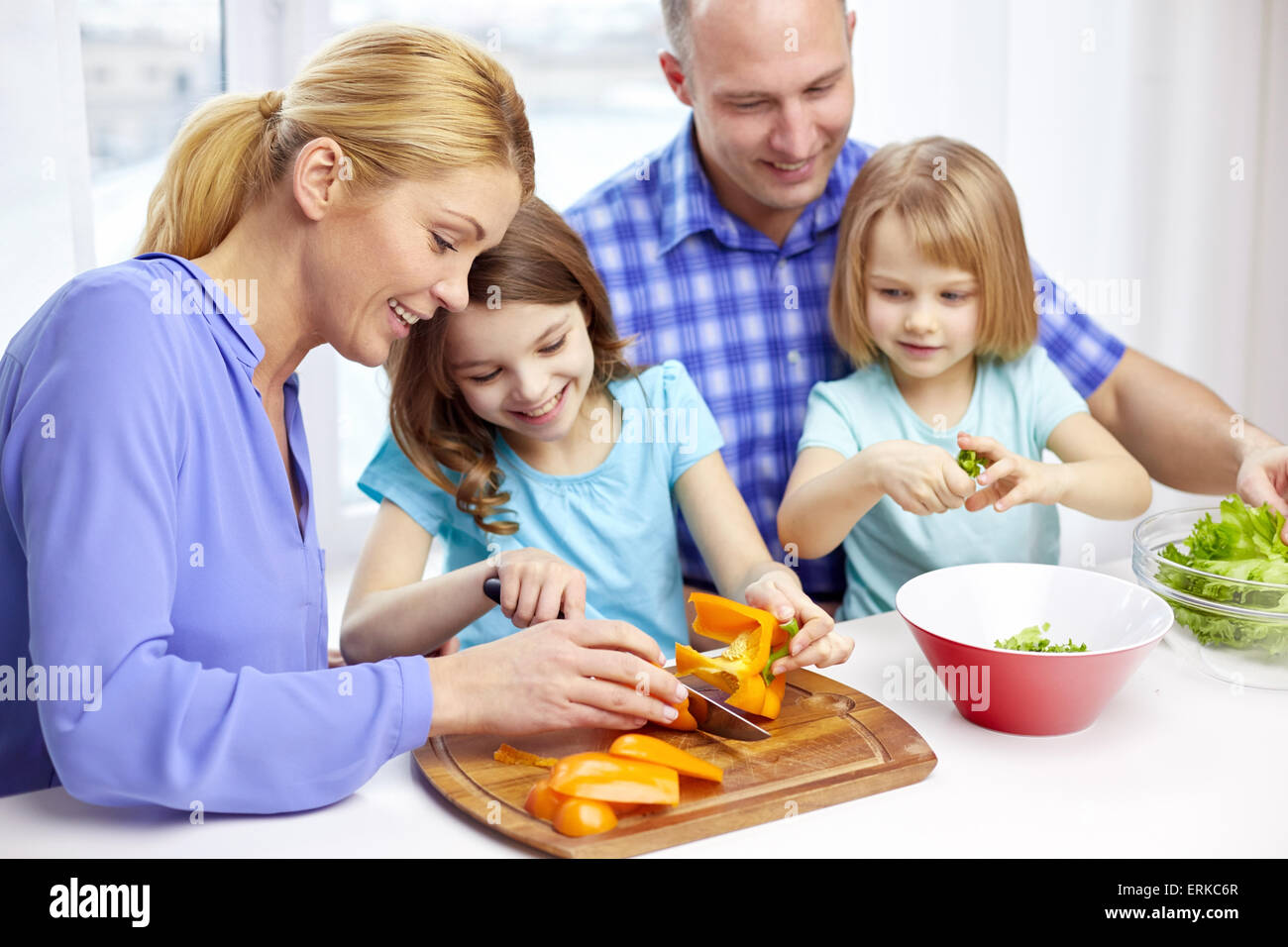 happy family with two kids cooking at home Stock Photo