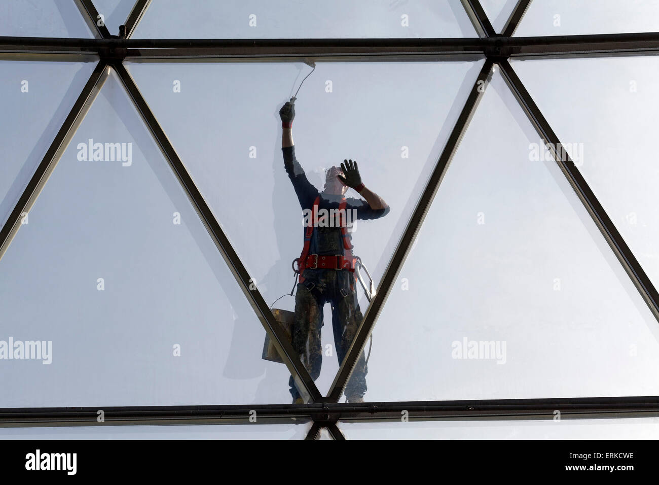 Painter painting the steel tube construction of a glass dome, Düsseldorf, North Rhine-Westphalia, Germany Stock Photo