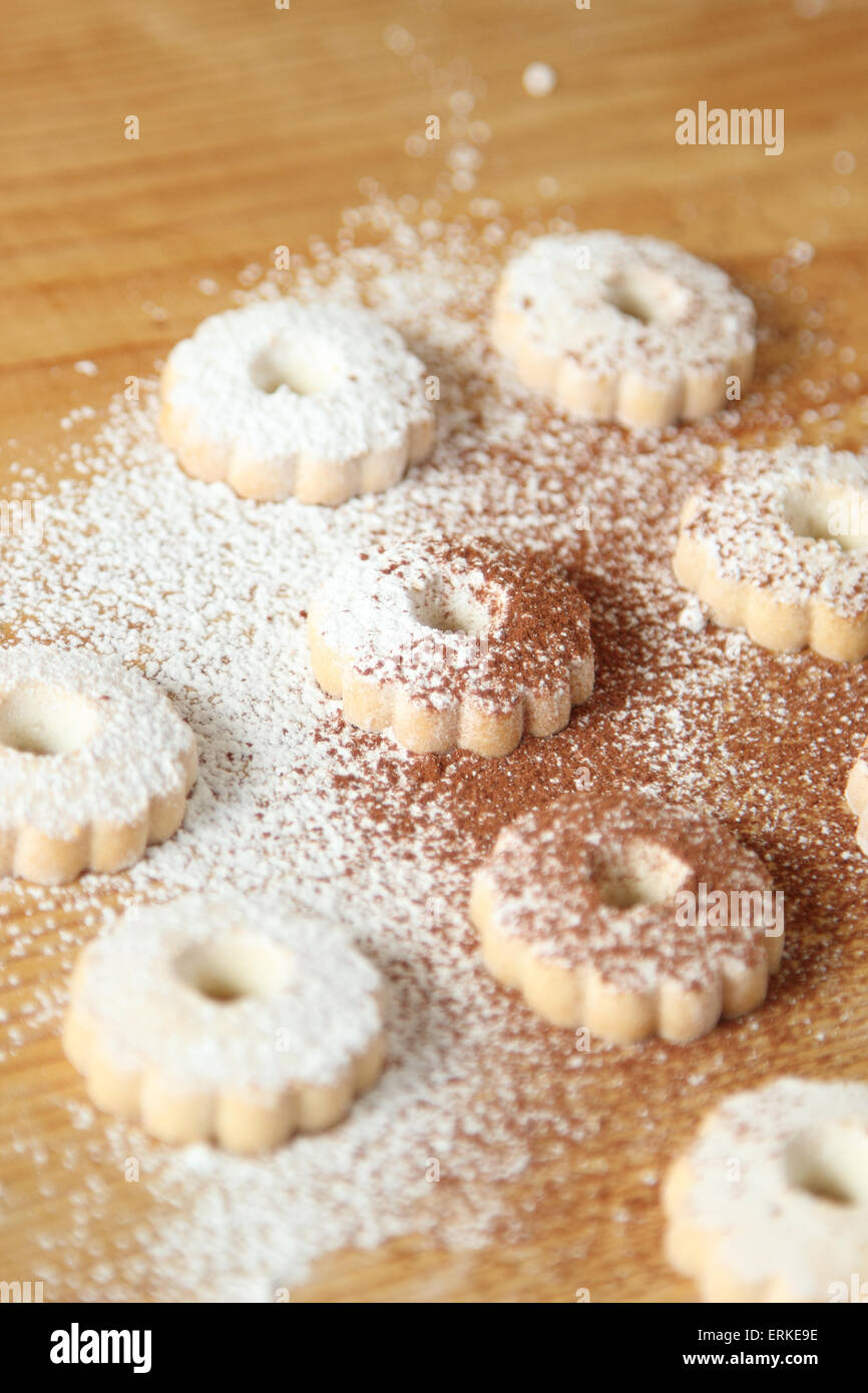 Italian canestrelli biscuits sprinkled with powdered sugar and cocoa. Vertical image Stock Photo