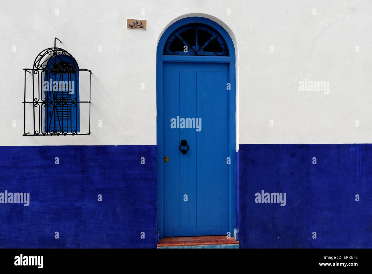 Housing front with blue front door, Asilah, Morocco Stock Photo