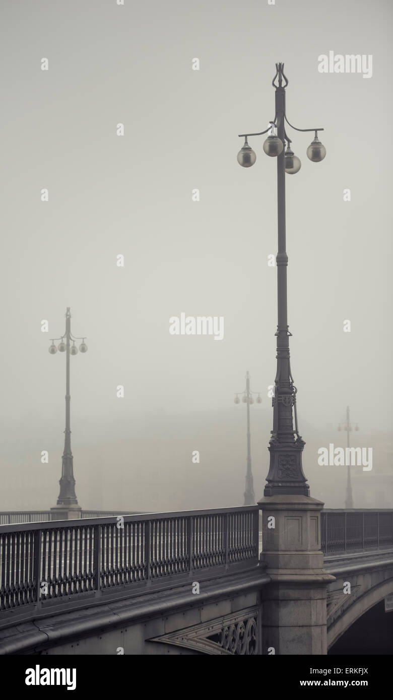 Empty bridge in heavy fog. Tranquil city scene with old architecture in Stockholm, Sweden. Stock Photo