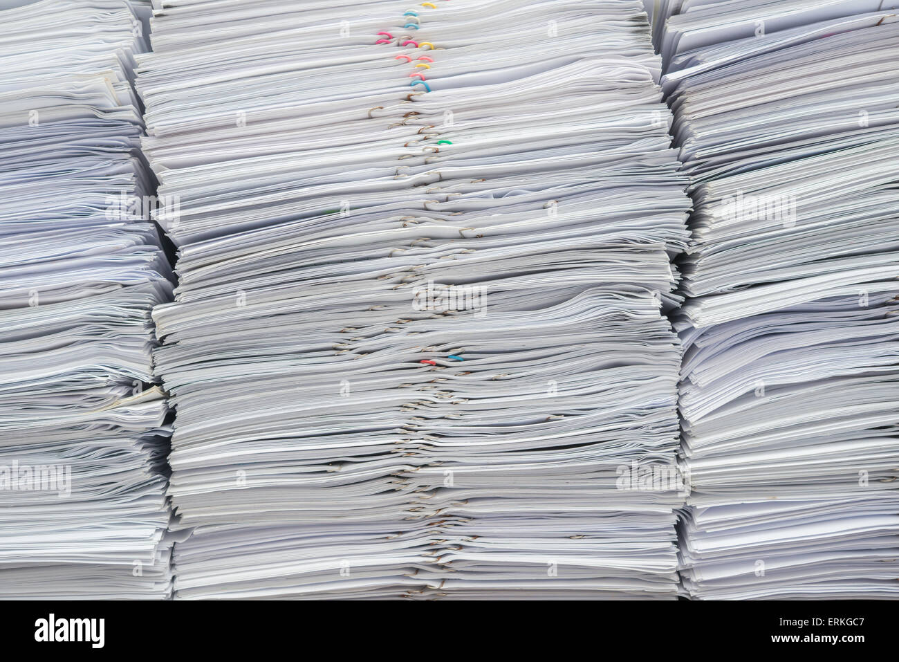 Pile of documents on desk stack up high Stock Photo
