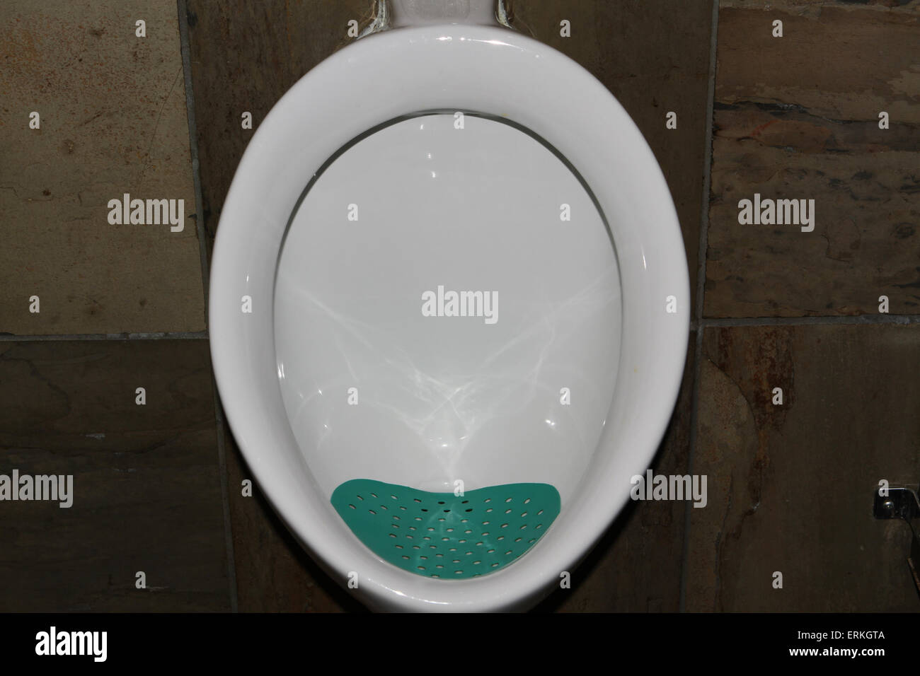 Urinal with green St Patrick's Day pad Stock Photo