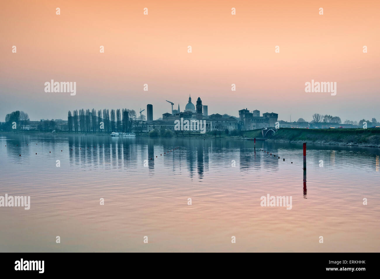 Mantova skyline at dusk reflected on still water lake with landmarks silhouette Stock Photo