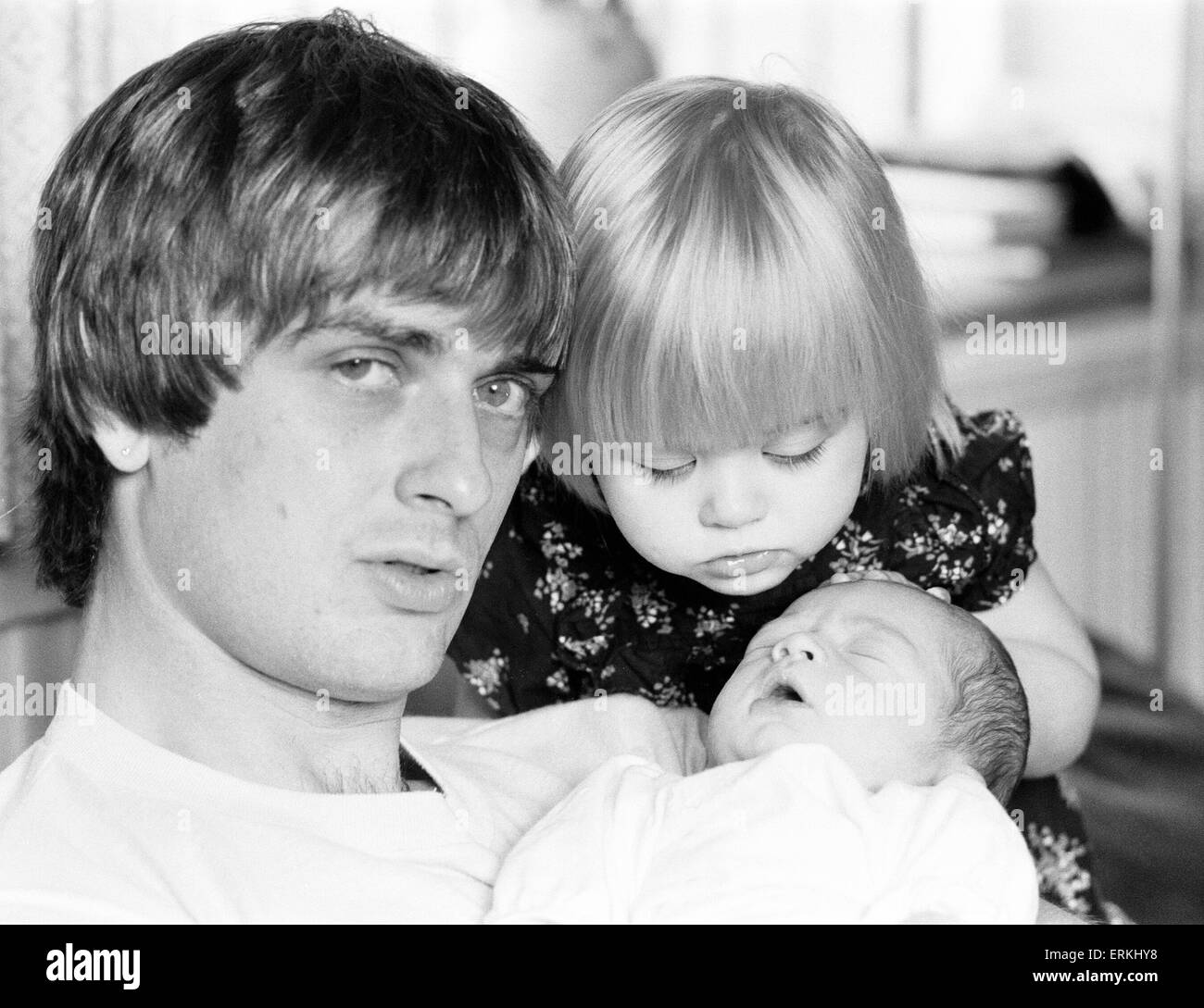 Mike Oldfield, musician and composer, pictured at home with family, eldest daughter Molly and baby son Dougal, Buckinghamshire, September 1981. Stock Photo