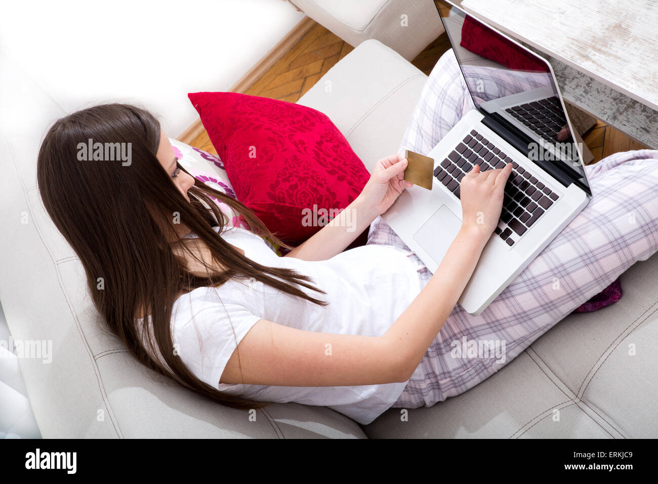 Young girl at home buying on line with the credit card Stock Photo