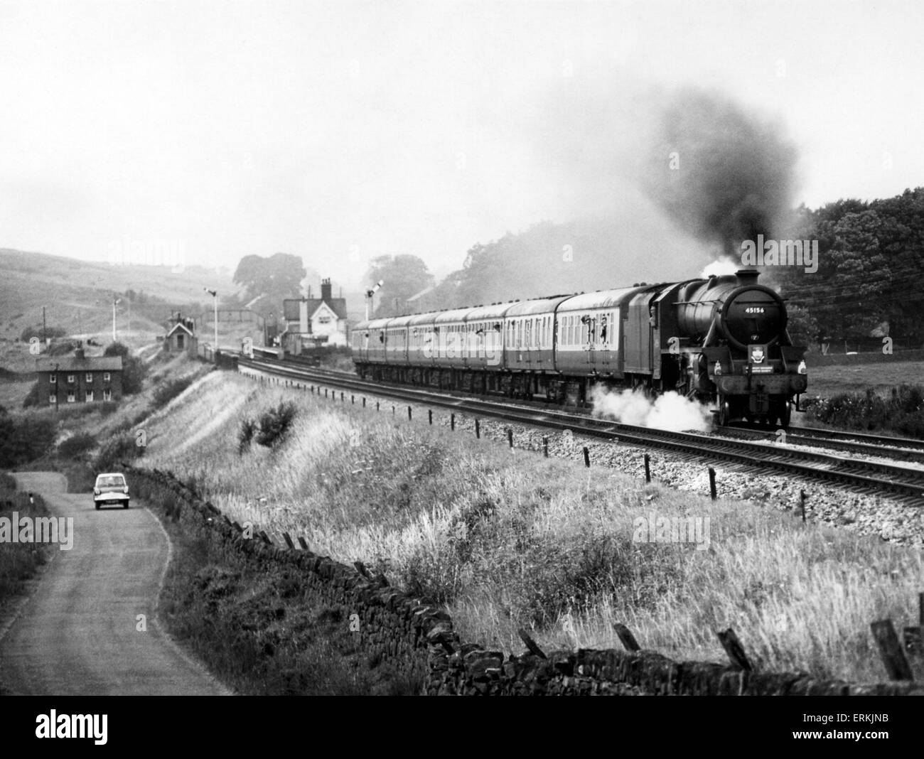 London Midland and Scottish Railway 4-6-0 Stanier Class Five steam locomotive number 45156, heads the G.C. Enterprises special train through Clapham between Carnforth and Settle. 4th August 1968. Stock Photo