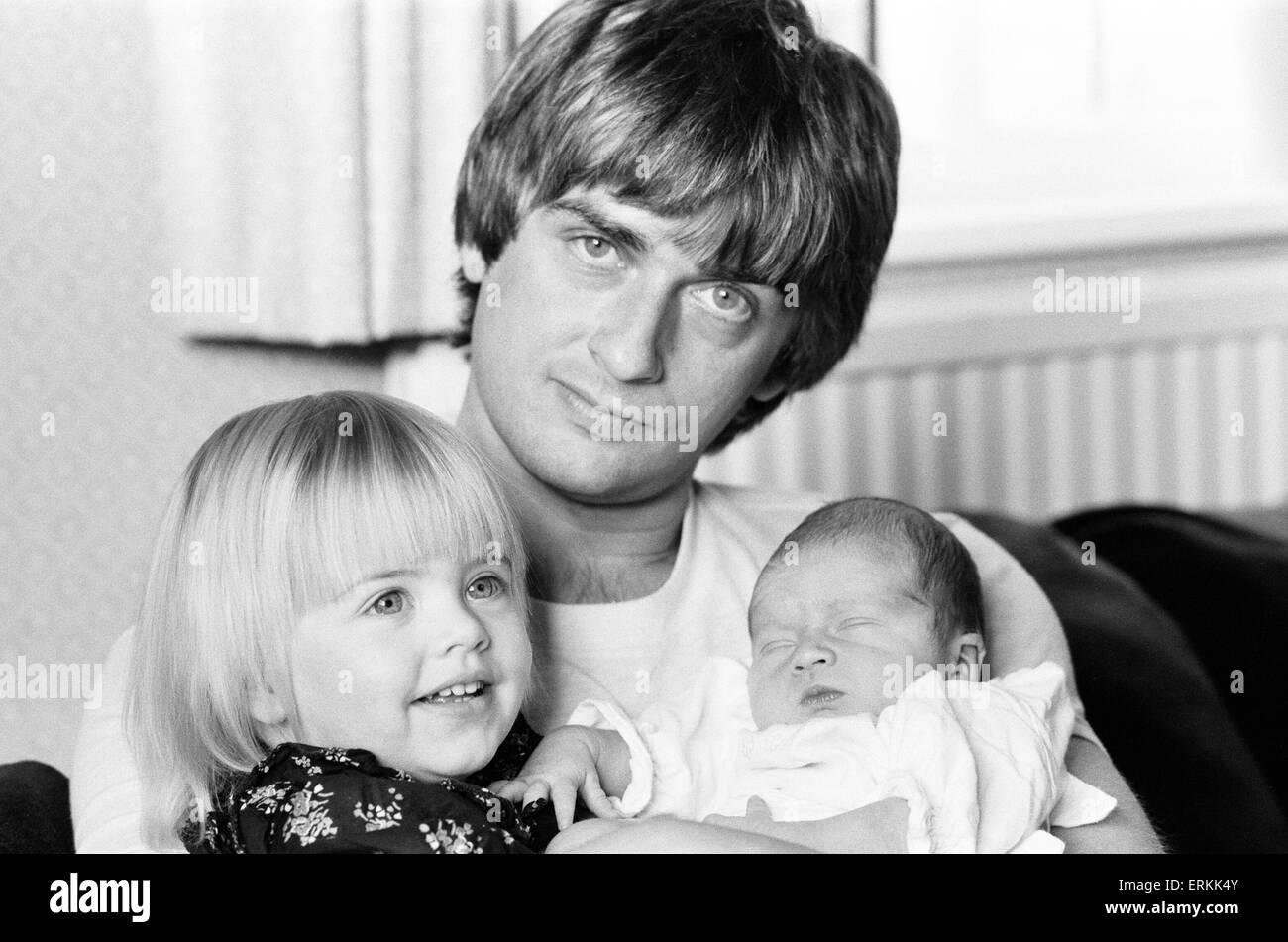 Mike Oldfield, musician and composer, pictured at home with family, eldest daughter Molly and baby son Dougal, Buckinghamshire, September 1981. Stock Photo