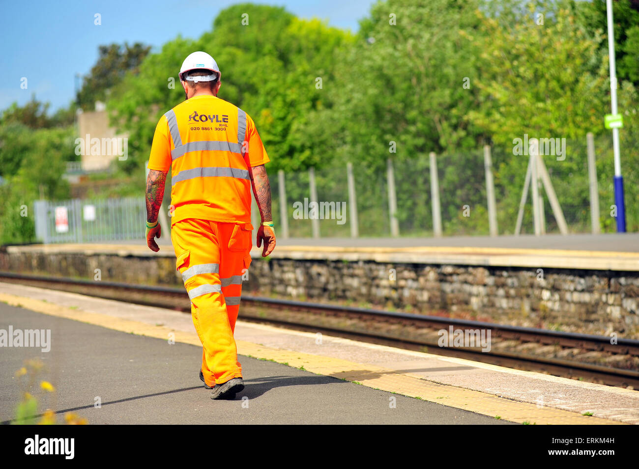 A British railway worker walks along a platform in Bristol. Stock Photo