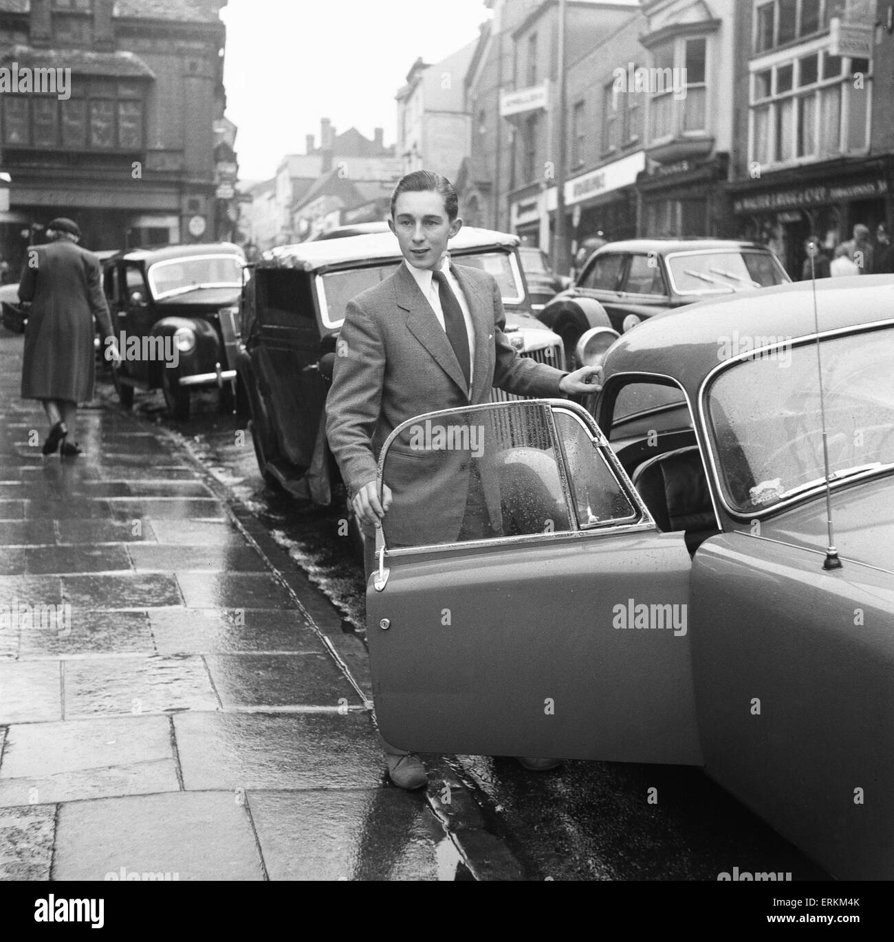 Jockey Tony Shrive seen here in outside the magistrate court in Andover, Hampshire where he faces careless driving charges. He is pictured with his M.G. sports car 20th October 1957 Stock Photo