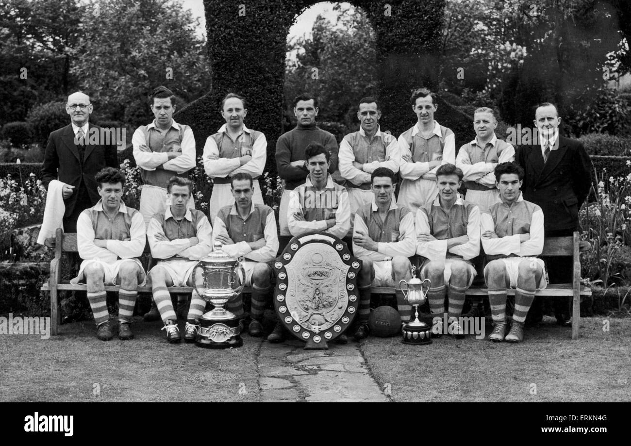 Alvechurch football club team group with trophies after winning the Redditch and District League championship, the A.E. Terry Memorial Cup as well as the Studley Charity Cup. Circa 1948. Stock Photo