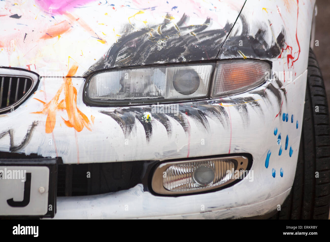 Eyelashes painted on light of Mazda Xedos 6 Auto car to make it look like an eye Stock Photo