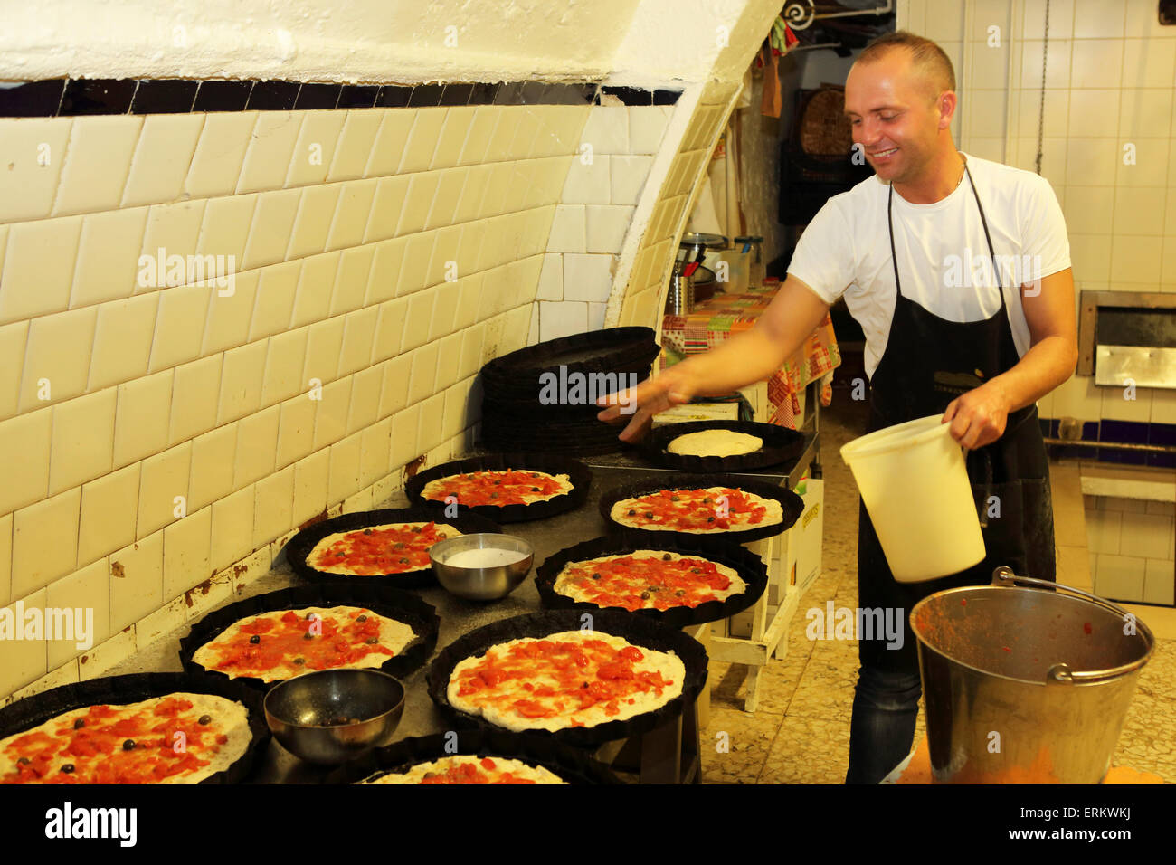 A baker at work making focaccia, a local delicacy, in a bakery in the Bari Vecchia quarter of Bari, Apulia, Italy, Europe Stock Photo