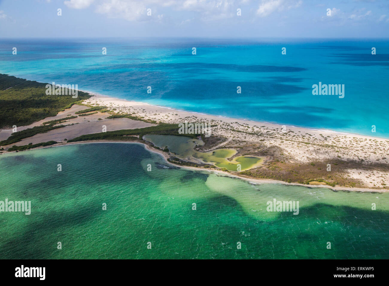 View of a corner of Barbuda, the Frigate Bird Sanctuary touches a thin strip of sand that separates the Caribbean Sea, Barbuda Stock Photo