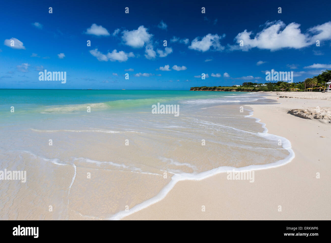 The waves of the Caribbean Sea crashing on the white sandy beach of Runaway Bay, north of the capital St. John's, Antigua Stock Photo