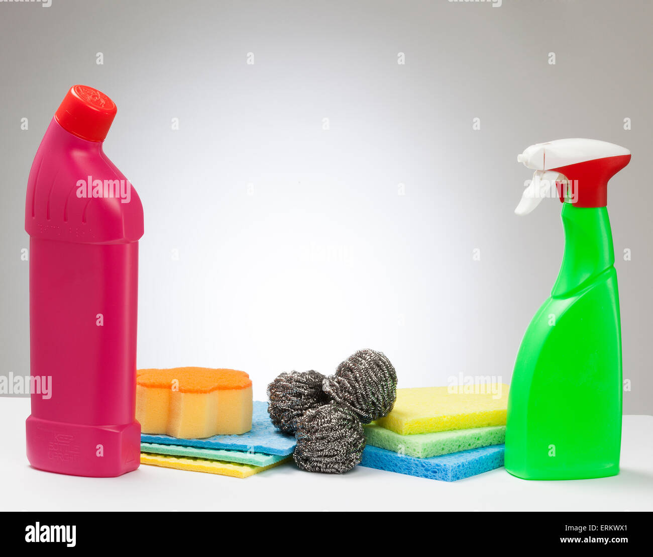Cleaning product containers and sponges with a spotlight white background Stock Photo Alamy