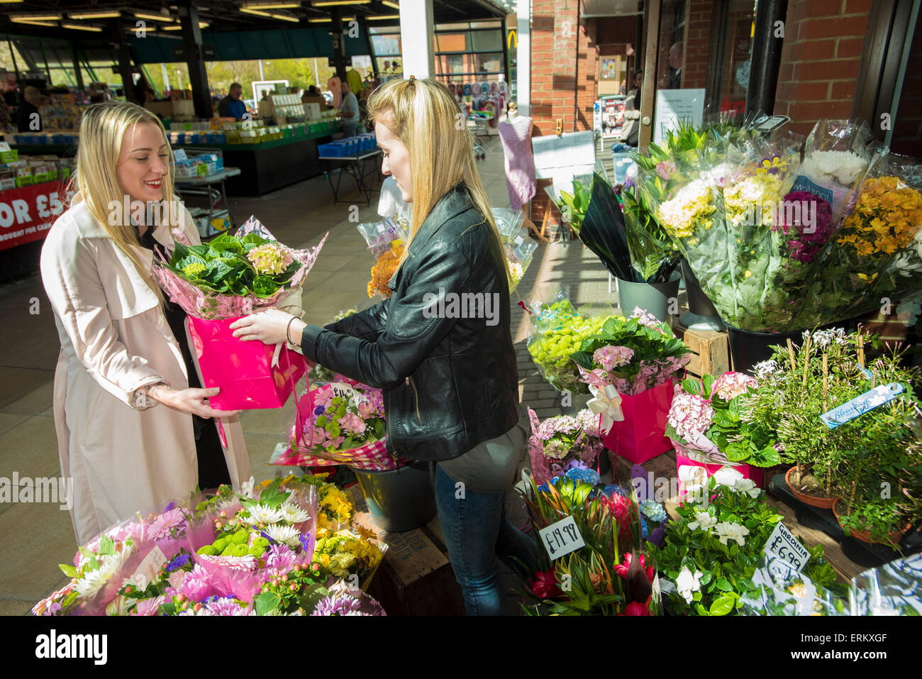 woman buying flowers from independent female florist . Florists