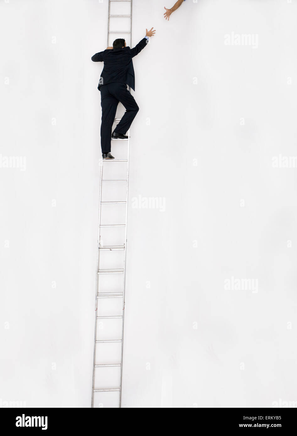 Man in business suit climbs a tall ladder, San Diego, California. Stock Photo