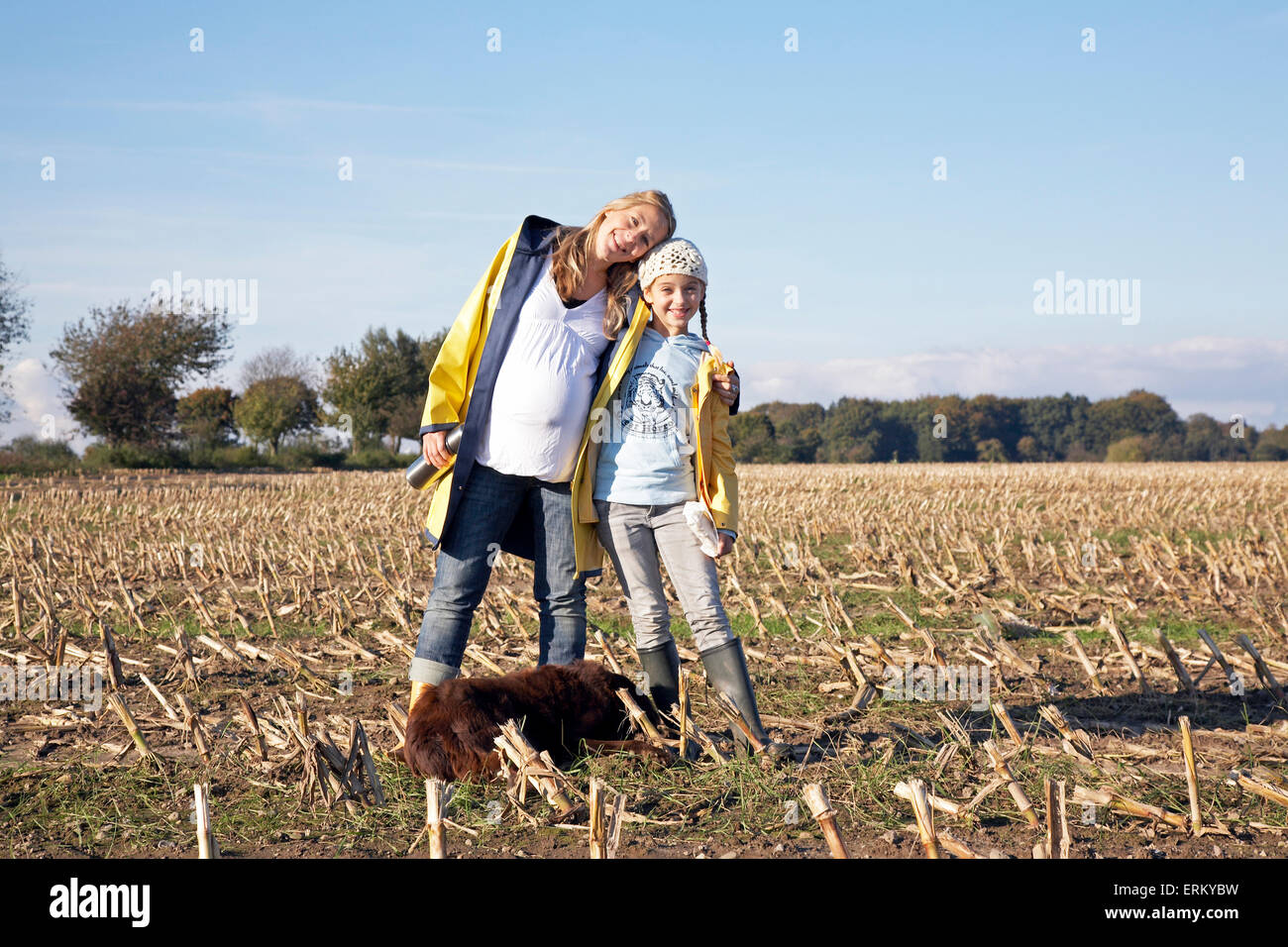 A pregnant mother and her daughter pose for a photograph in a field near Hamburg, Germany. Stock Photo