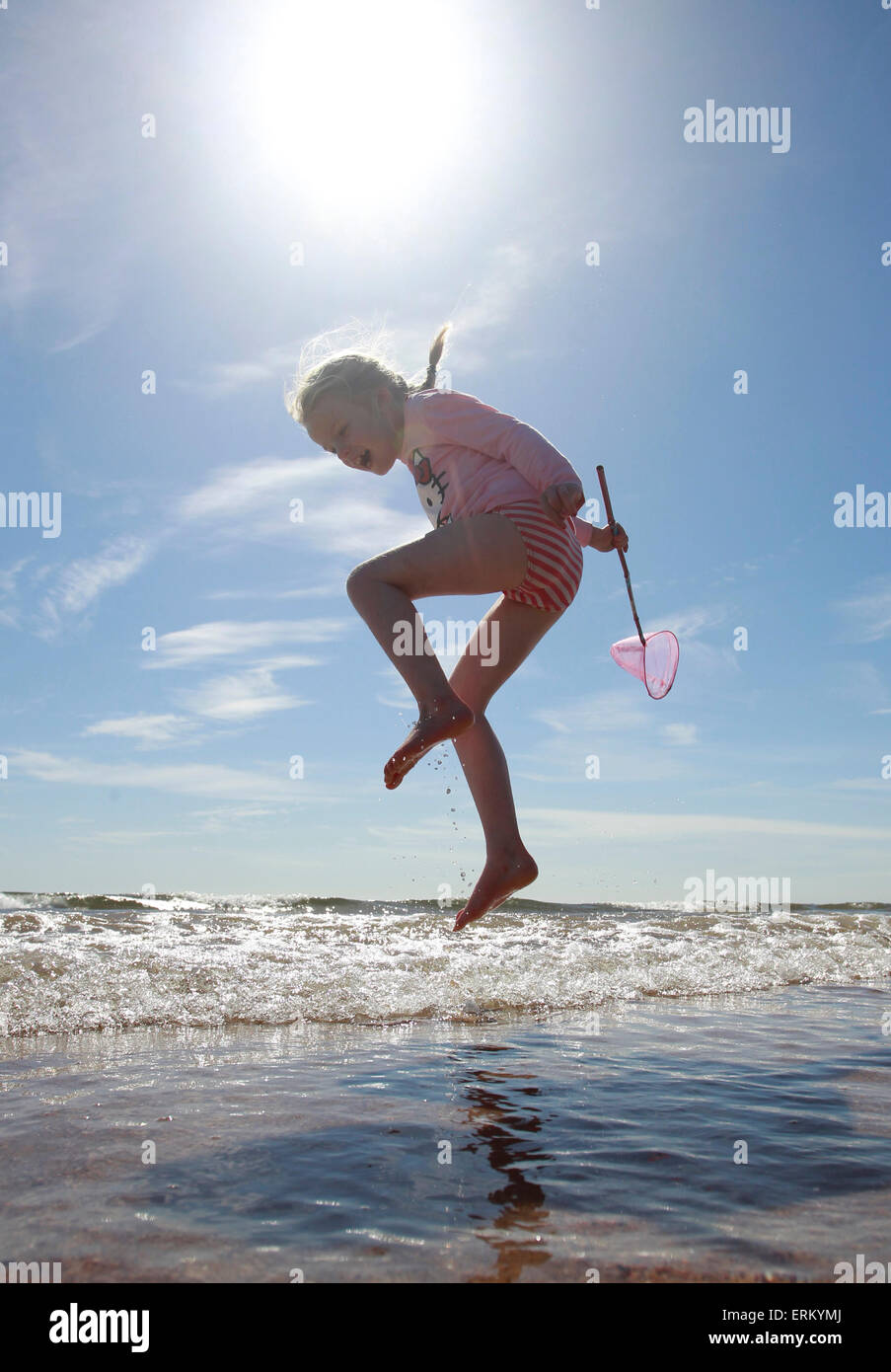 Alnmouth Beach, Northumberland, UK. 4th June, 2015. UK Weather: Frances Tidswell-Thompson (7) jumping waves on Alnmouth Beach Northumberland. Credit:  West Yorkshire Images/Alamy Live News Stock Photo