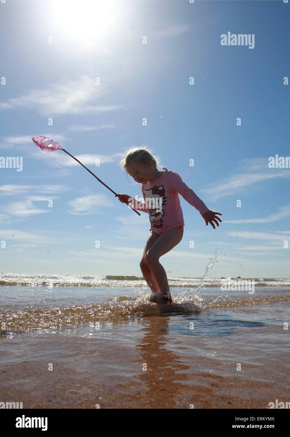 Alnmouth Beach, Northumberland, UK. 4th June, 2015. UK Weather: Frances Tidswell-Thompson (7) jumping waves on Alnmouth Beach Northumberland. Credit:  West Yorkshire Images/Alamy Live News Stock Photo