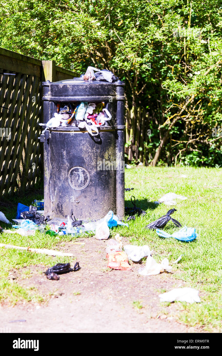 overflowing waste bin garbage trash on floor council cutback cutbacks