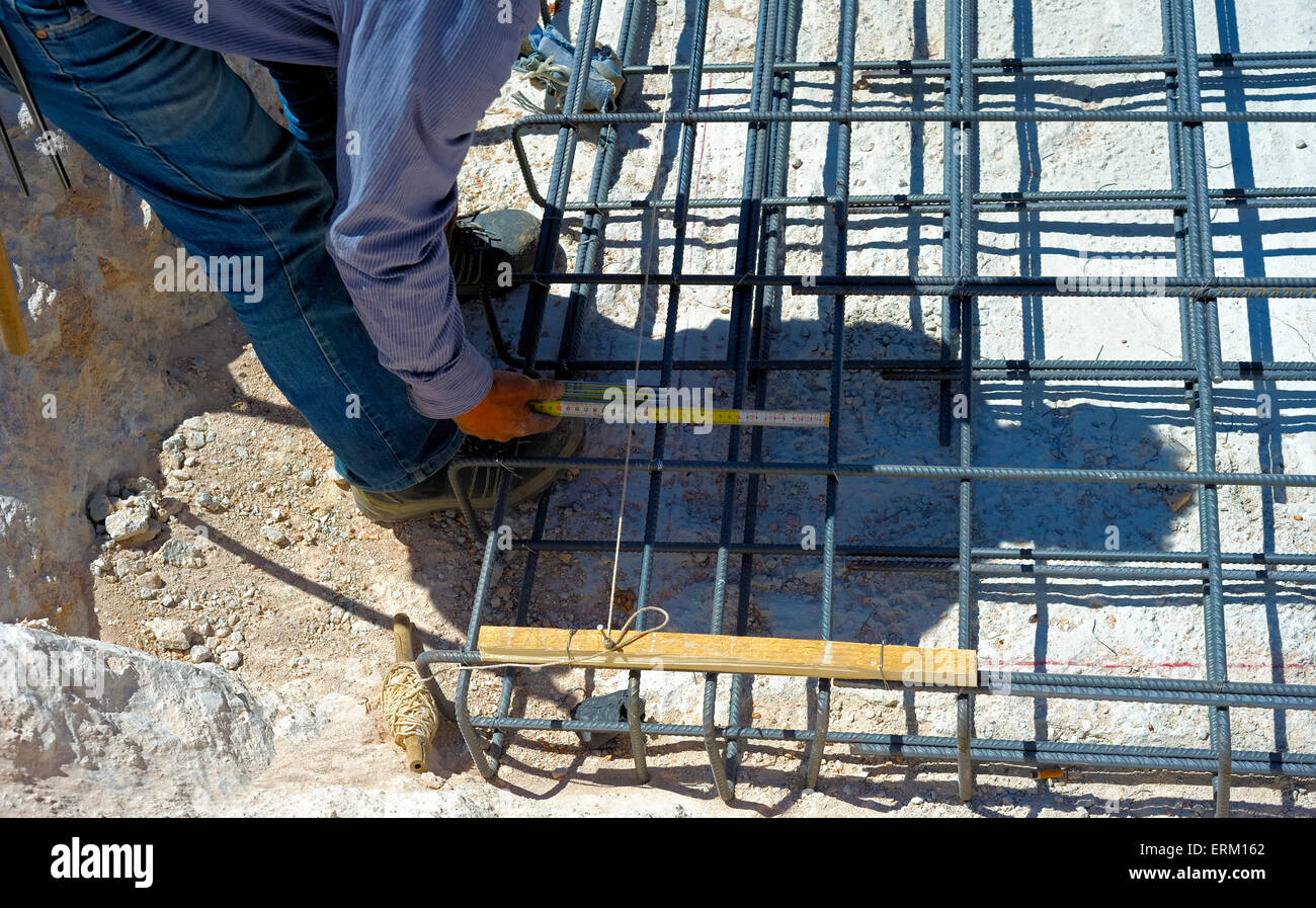 worker measure the distance between the steel reinforcement Stock Photo