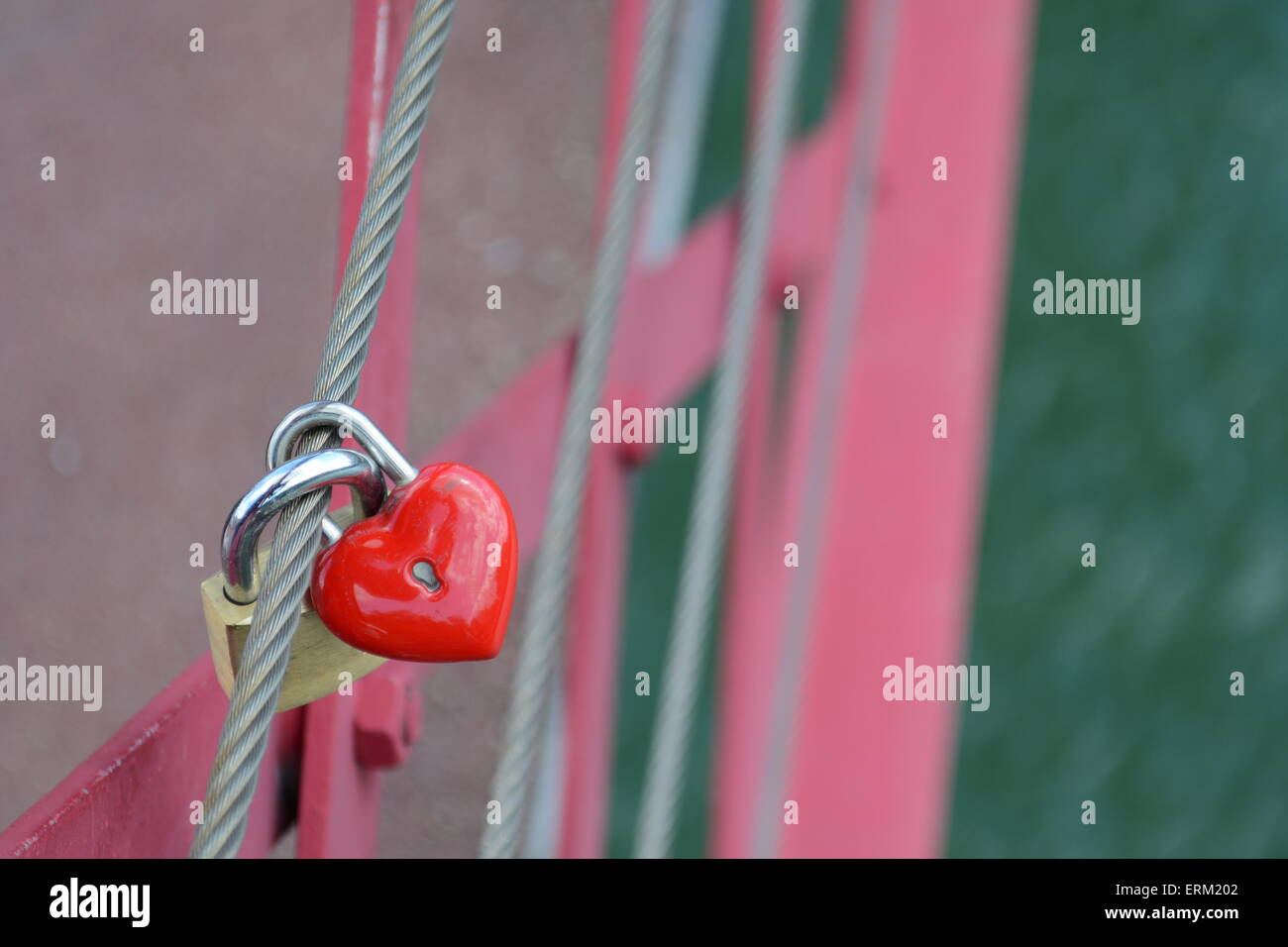 Red heart shaped locket and padlock locked together on bridge Stock ...