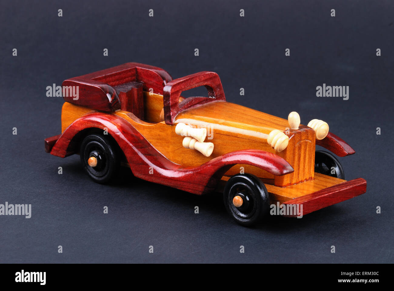 A toy car made of wood on black Stock Photo - Alamy