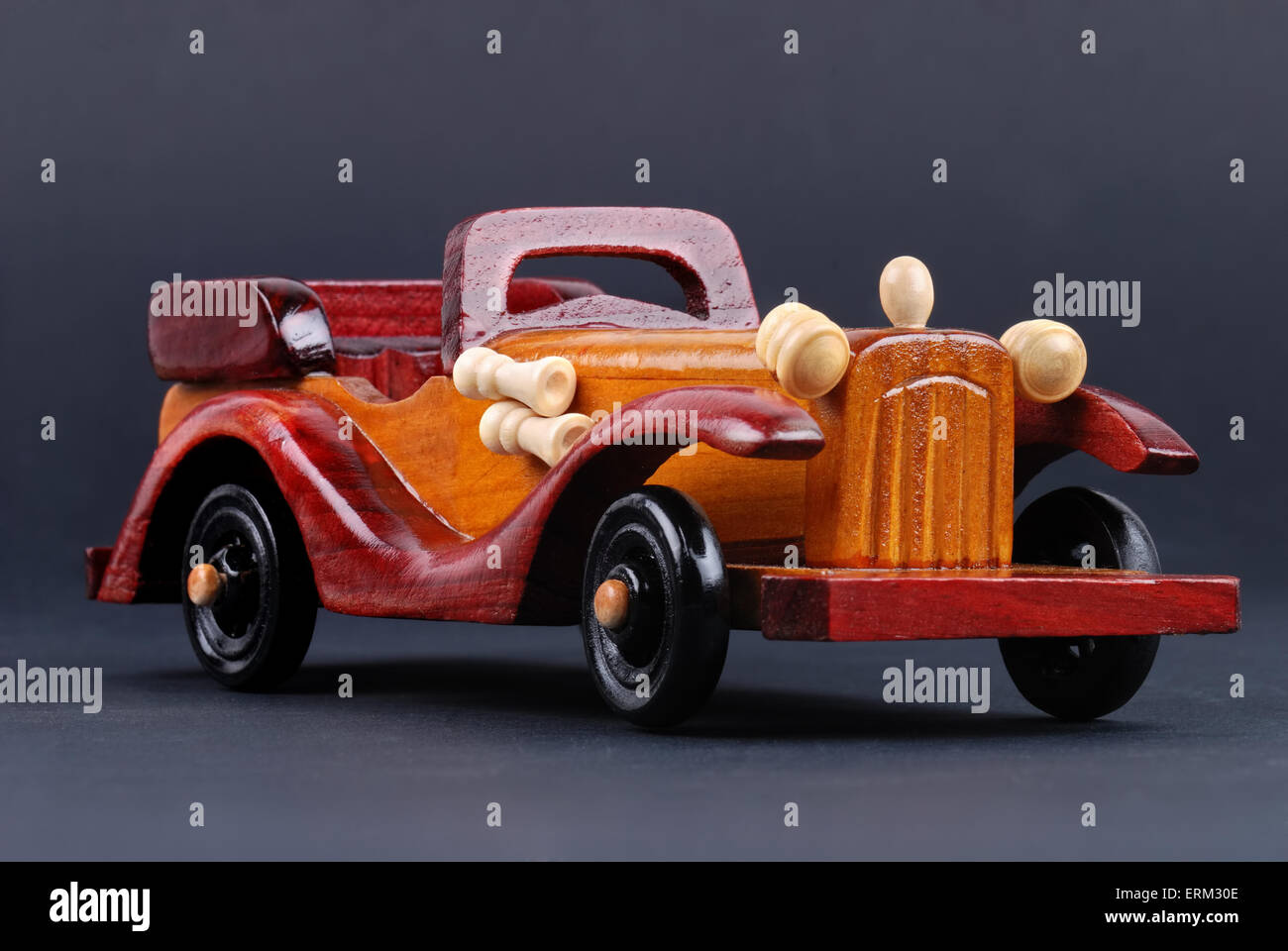 A toy car made of wood on black Stock Photo - Alamy