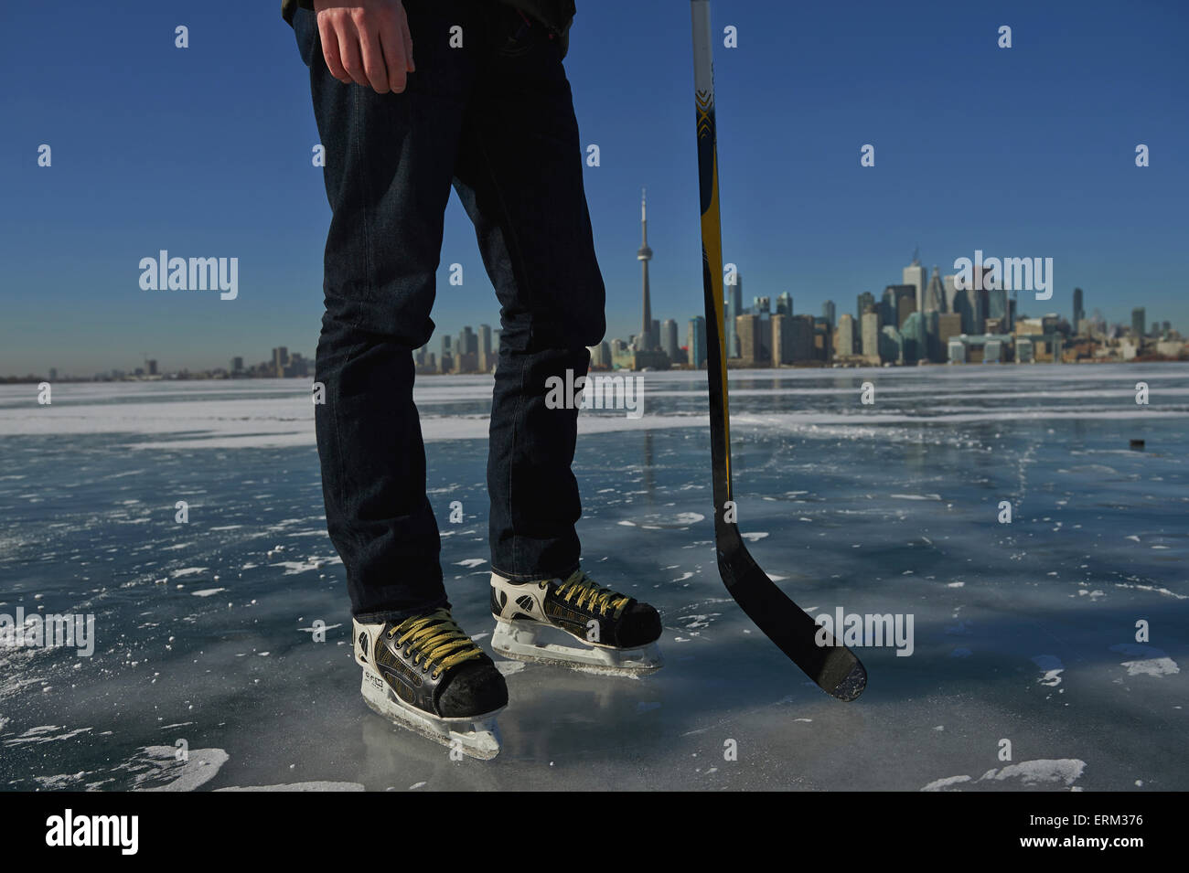 Hockey player and city skyline from Ward's Island; Toronto, Ontario, Canada Stock Photo