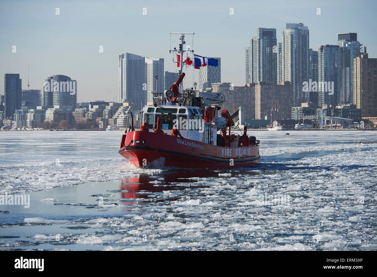 Fire rescue boat against city skyline from Ward's Island in winter; Toronto, Ontario, Canada Stock Photo