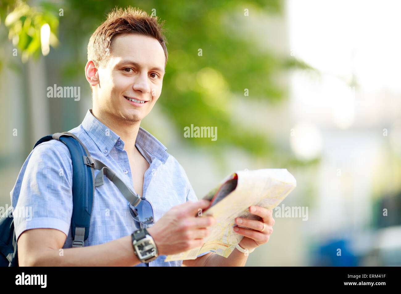 Young man with map Stock Photo - Alamy