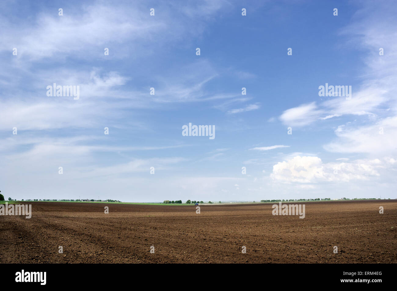 Tractor plowing the land. Arable land and sky Stock Photo - Alamy