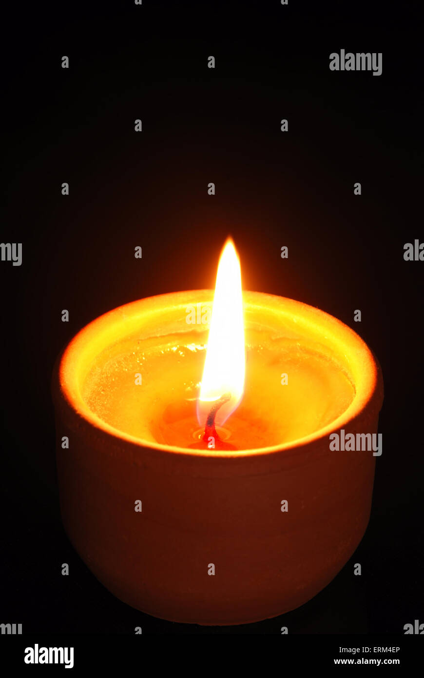 Closeup of burning candle isolated on black background Stock Photo - Alamy